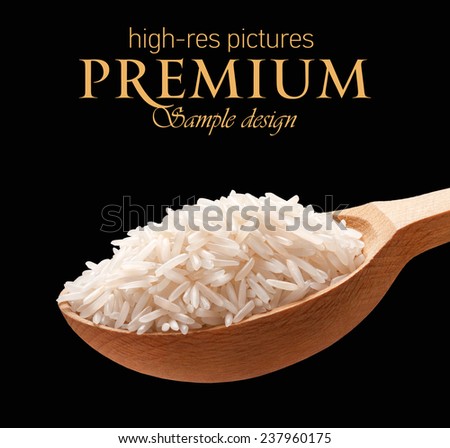 Basmati rice in a wooden spoon / cereal on wooden spoons isolated on black background with place for your text