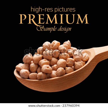 Chickpea in a wooden spoon / beans on wooden spoon isolated on black background with place for your text