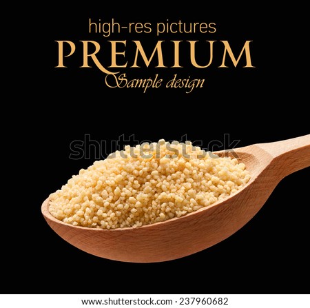 Couscous (cooking) in a wooden spoon / cereal on wooden spoons isolated on black background with place for your text