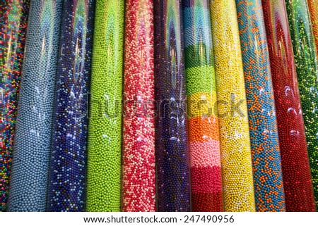 Variety of sweets / photography of transparent plastic tubes full of thousands of colorful candies