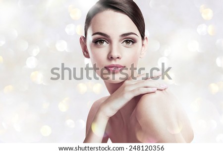Beautiful young woman with make up face / photoset of attractive brunette girl on blurred background with bokeh