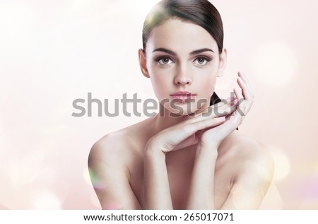 Charming young female with perfect makeup, skin care concept / photoset of attractive brunette girl on blurred beige background with bokeh
