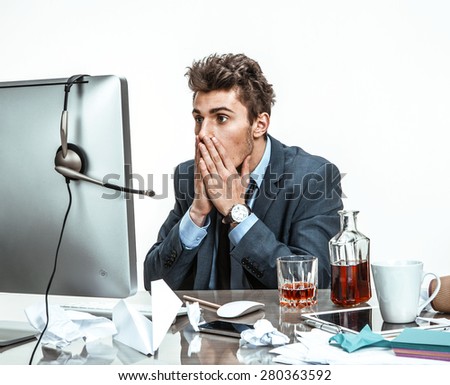 Businessman looking at computer screen with horror / modern office man at working place, depression and crisis concept