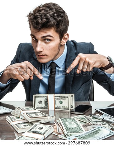 Manager showing his earnings, profit, income, earnings, gain, benefit, margin / modern businessman at his desk with computer and a lot of money