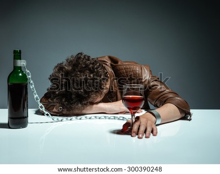 Young man passed out from alcohol / photo of youth addicted to alcohol, alcoholism concept, social problem