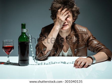 Lonely executive tensed due to job loss / photo of youth addicted to alcohol, alcoholism concept, social problem