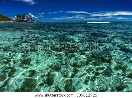 Turquoise tropical sea under the blue sky, vacation background