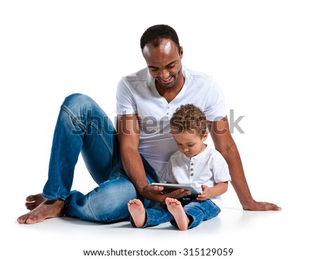 Happy father with his son looking at touchpad PC. Learning and early education concept / photos of Hispanic man and mixed race boy over white background