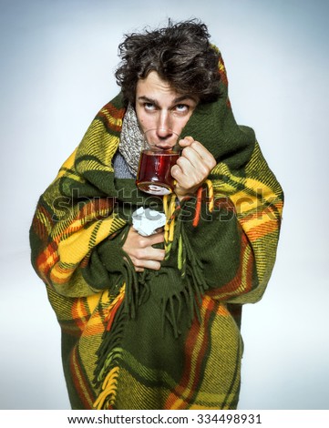 Ill Man covered with plaid blanket with hot tea/ sick man  suffering cold and winter flu virus. Medication or drugs abuse, healthcare concept