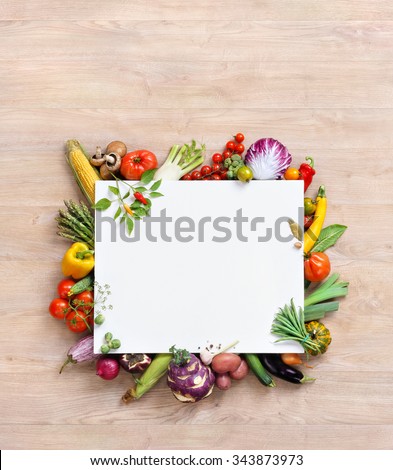 Healthy food background and Copy space / studio photography of white paper surrounded by fresh vegetables on old wooden table. Healthy food background, top view. High resolution product,