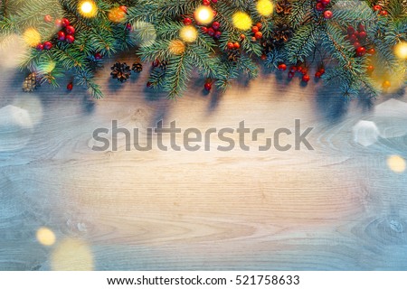 Christmas fir tree with lights on wooden background. Merry Christmas and Happy New Year!! Top view.