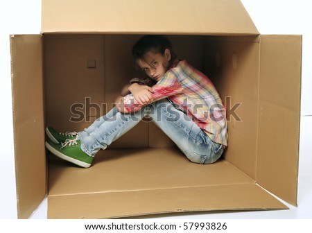 Angry teenage girl siting in box and irritating - bad mood, injury