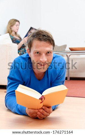 Couple reading together in the living room