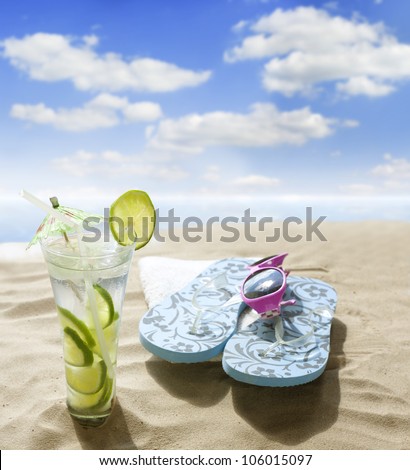 sunglasses drink in sand on beach at sea holiday  concept