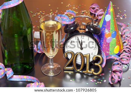 2013 happy new year party with clock champagne and hat on table