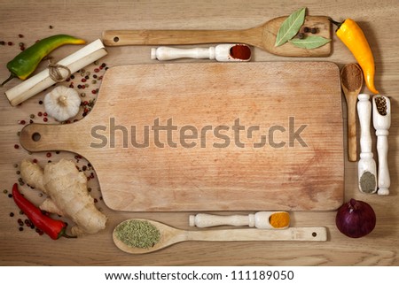 Vegetables and  spices vintage border and empty cutting board