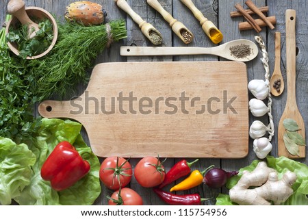 Vegetables and spices vintage border and empty cutting board