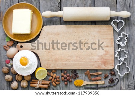 Baking cookies with spices and empty cutting board abstract background
