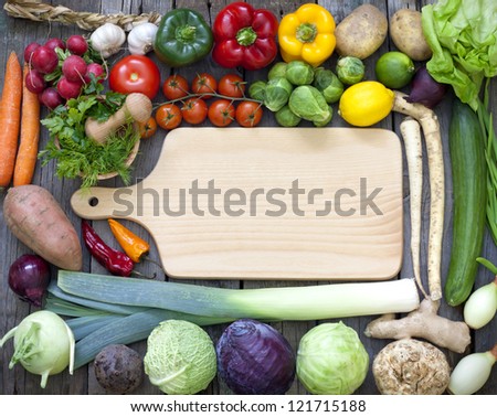 Vegetables and spices vintage border and empty cutting board