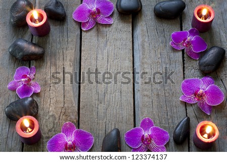 Orchid and stones on wooden boards spa cosmetic abstract vintage border