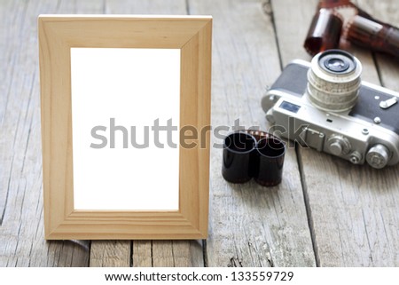 Old empty photos frame with retro camera background concept