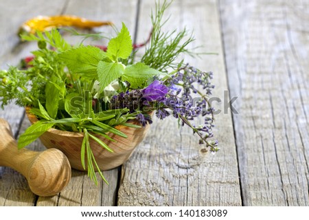 Fresh herbs and spices on vintage wooden boards closeup