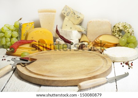 Many types of cheese on cutting board abstract composition