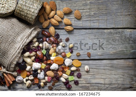 Nuts and dried fruits on vintage wooden boards still life