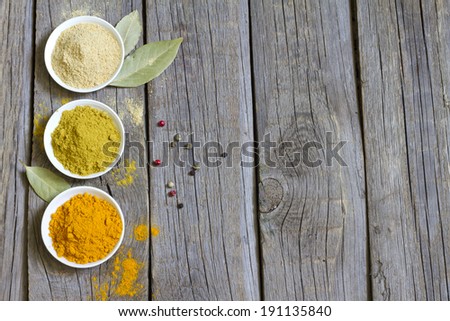 Herbs and dried spices on wooden board