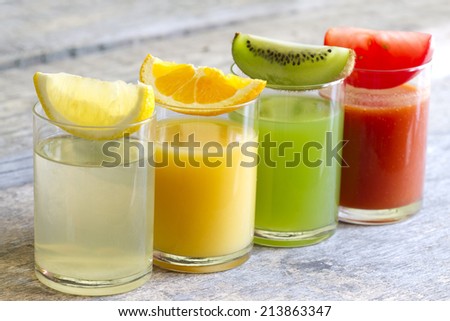 Fresh juice in glass with slices of fruits and vegetables