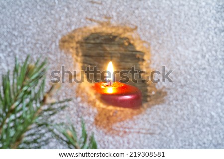 Christmas candles on a snowy window concept