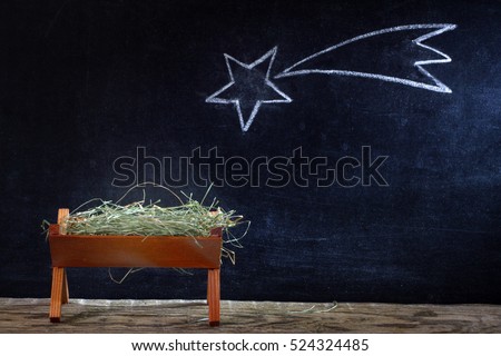Birth of Jesus with manger and star on blackboard abstract christmas nativity scene
