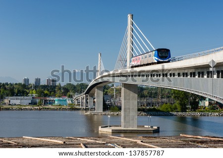 Vancouver, Canada - May 08: Canada Line Train Passes Bridge On May 08, 2013. The Canada Line Is Vancouver\'S New Rapid Transit Rail Link Connecting Airport To Downtown Vancouver.