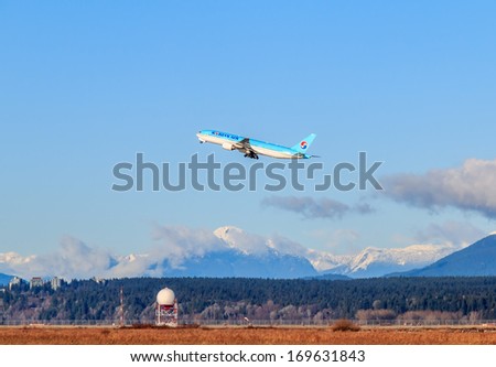 VANCOUVER, CANADA - JANUARY 03, 2014: Korean Air airplane takes off in Vancouver International Airport. Korean Air Lines Co. is both the flag carrier and the largest airline of South Korea
