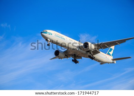VANCOUVER, CANADA - JANUARY 16, 2014: Cathay Pacific airplane on final approach to Vancouver International Airport. Cathay Pacific is the international flag carrier of Hong Kong.