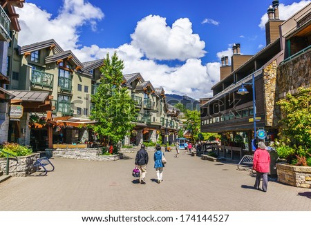 WHISTLER, BRITISH COLUMBIA, CANADA - JUNE 10, 2013: Tourists ramble on the street of Whistler, co-host of the 2010 Olympic Games. It is a Canadian resort town 125 kilometers north of Vancouver.