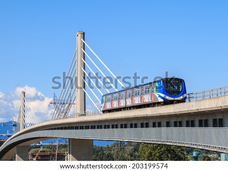 VANCOUVER, CANADA - MAY 30, 2014: Canada Line train passes bridge on May 30, 2014. The Canada Line is Vancouver new rapid transit rail link connecting airport to downtown Vancouver.