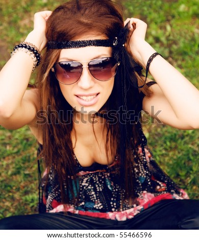 stock photo Beautiful young hippie girl sitting in the grass