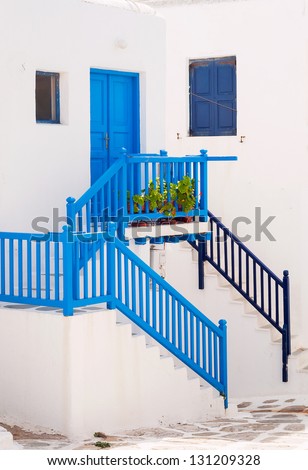 White and blue colors in the Greek architecture. Classic home on the islands in Greece with stairs