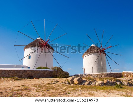 Two windmills of Mykonos. White buildings, blue sky