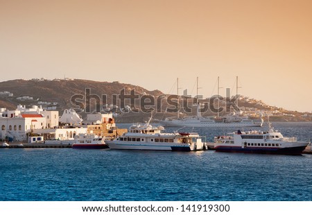 Ships, boats and fishing boats at sunset on the island of Mykonos. Greece.