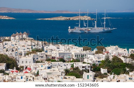 Top view of the town of Mykonos Island and a sailing ship in the blue sea ...