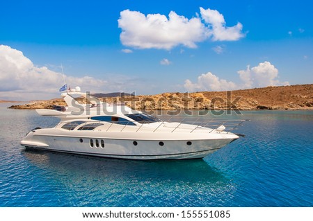 Yacht In The Sea Around The Island On A Background Of The Sky With Clouds