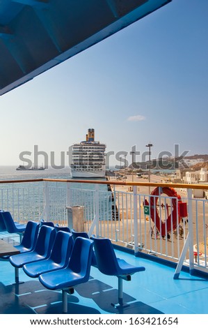 The view from the deck of a passenger ship in the port of the Greek islands with cruise ship.