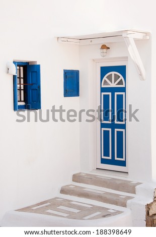 Old blue door and window and steps, painted white. Greece. Mykonos.