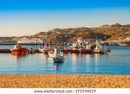 Boats in the sea bay near the town of Mykonos in Greece against the sky