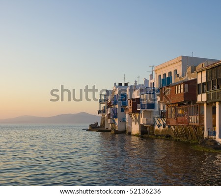 Buildings with balconies at Little Venice on the island of Mykonos in the sunset