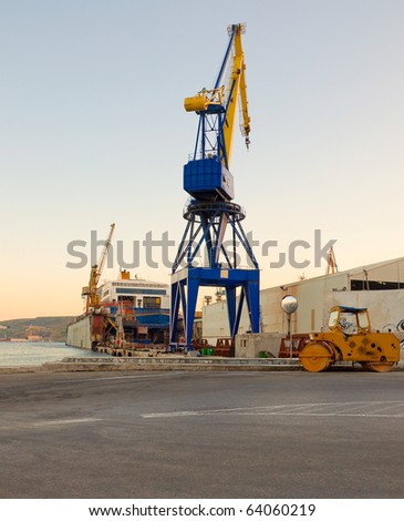 The crane at the port near the sea.