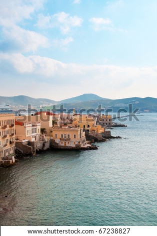 Houses along the sea on the island of Syros in Greece - is typical for Greece