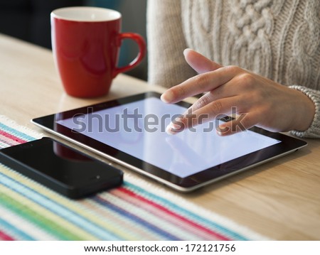 Women Hands With Tablet Computer And Phone On The Table